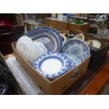 Box containing blue and white meat platters plus floral decorated side plates and dishes