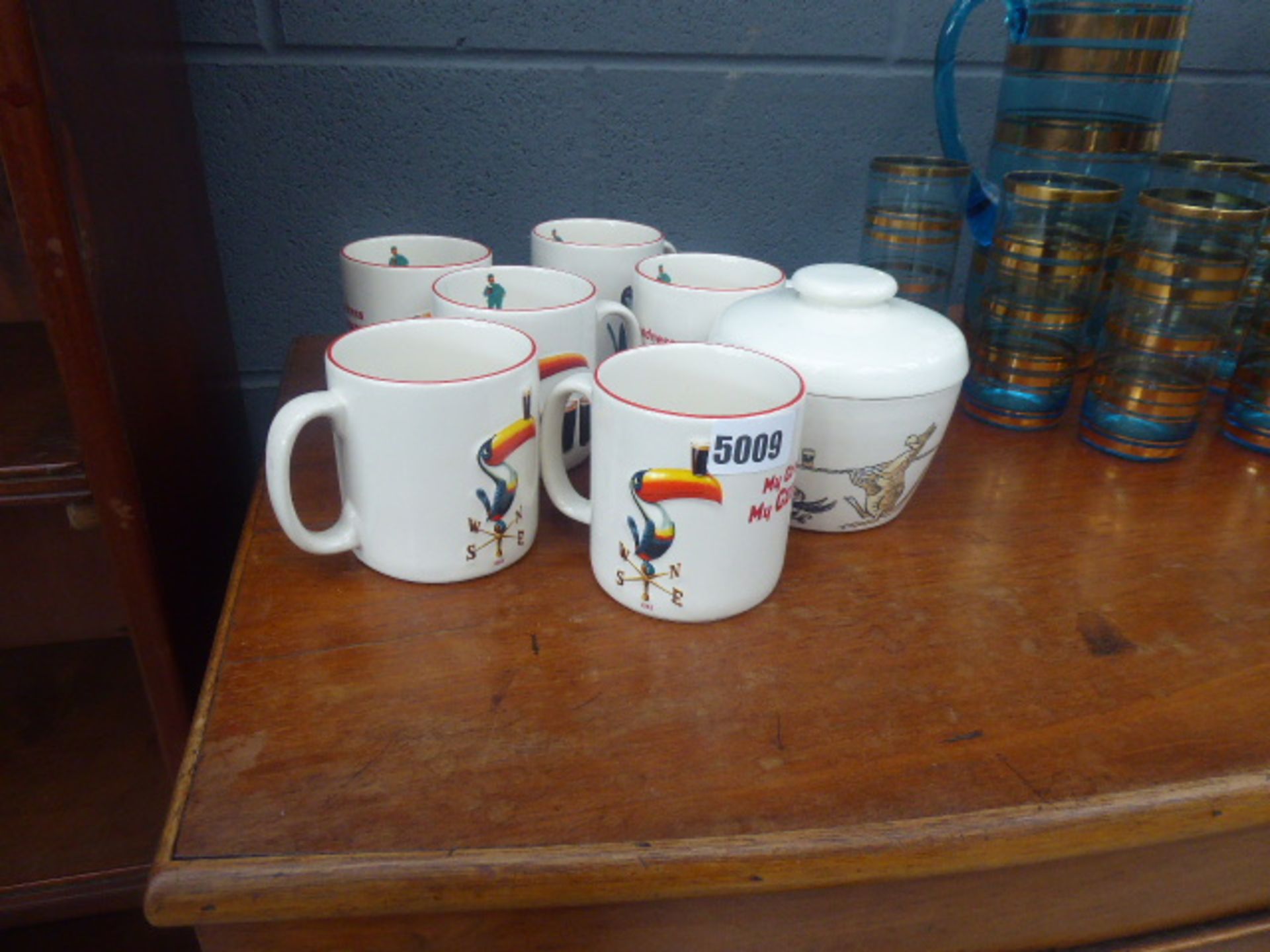 Quantity of Guiness advertising works in the form of mugs and a sugar bowl