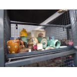 Cage containing commemorative magazines, cufflinks, a compact, ornamental figures of dogs, celery