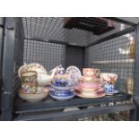 Cage containing a quantity of china cups and saucers plus teapots