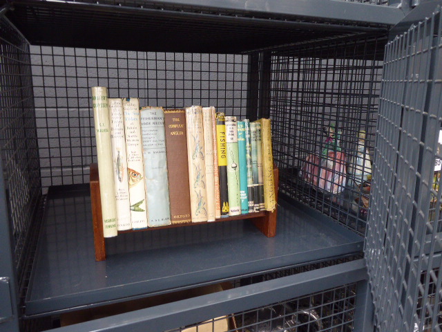 Cage containing a quantity of angling related books