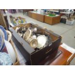 Box containing a quantity of silver plates to include teapots, candlesticks, sugar bowls, serving
