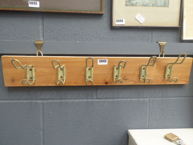 Set of coat racks on pine board