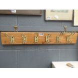 Set of coat racks on pine board