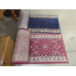 2 carpet runners 6.5m long and 5m long, one in red and one in blue