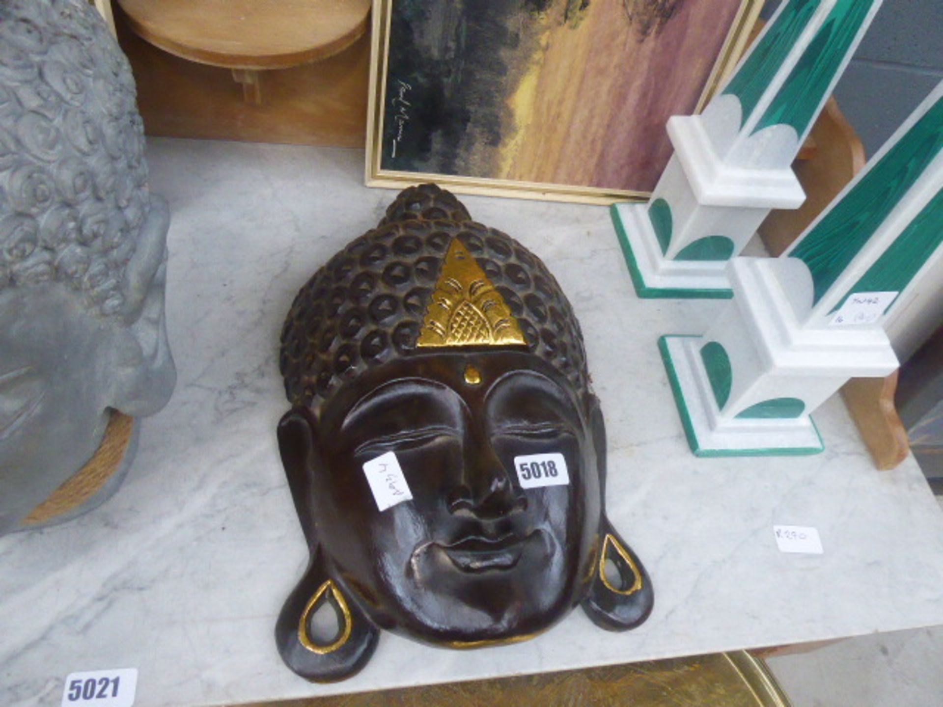 Brown wooden Buddha's mask with gilt decoration