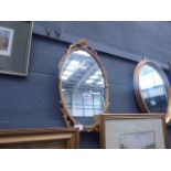Oval mirror in decorative gilt frame