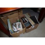 2 boxes containing a barometer, collectors books, a brass trivet, games and glassware