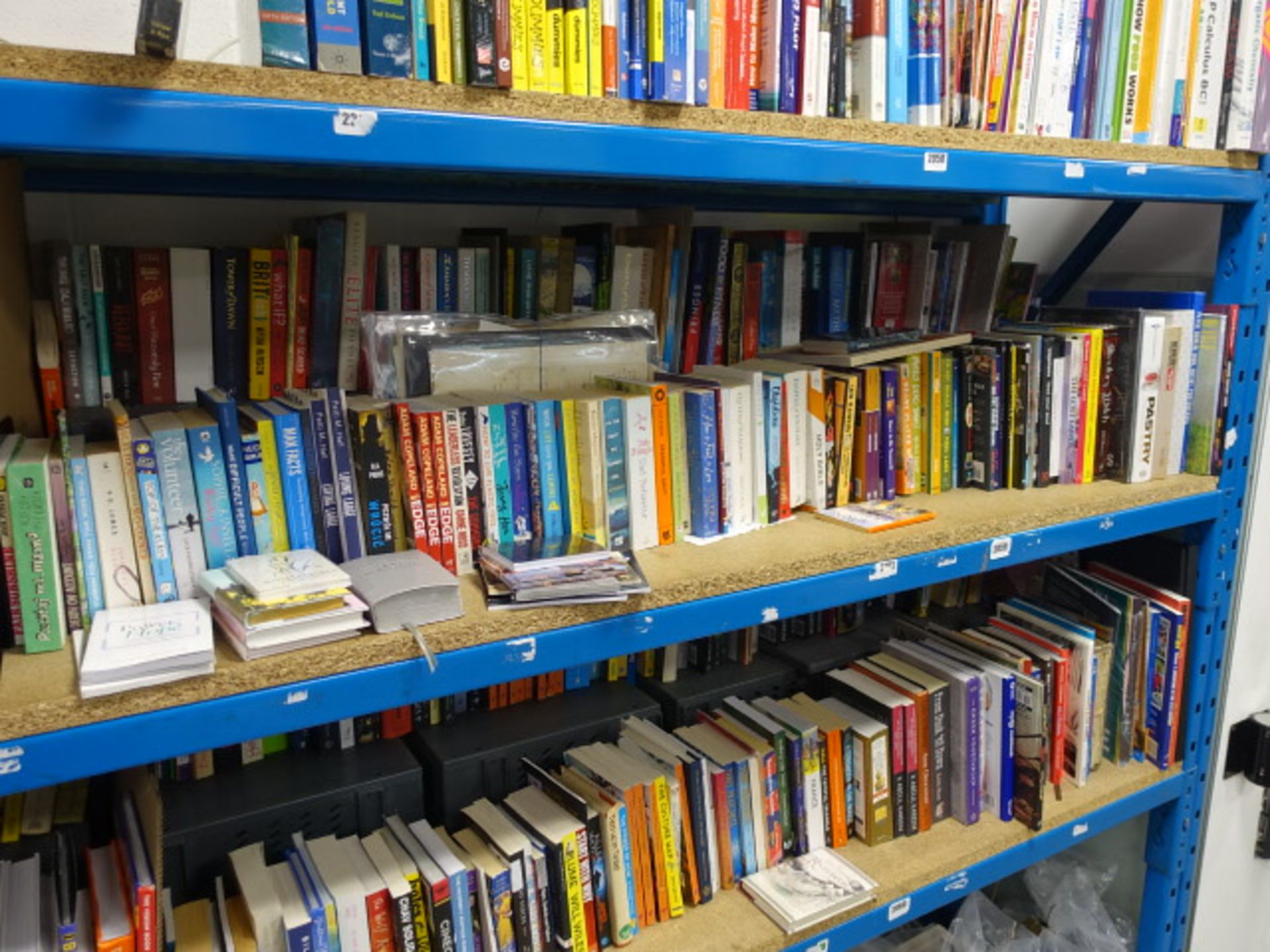 Shelf comprising of hardback and paperback novels, reference materials, cookbooks and manuscripts