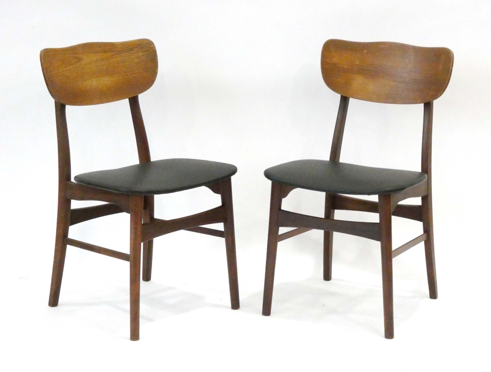 A pair of 1960's Danish dining chairs with shaped teak backs and black seats