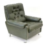 A 1970's green button upholstered lounge armchair on chromed feet