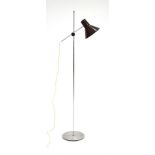 A 1970's standard lamp with a single brown enamelled shade on an aluminium shaft
