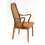 A 1970's Danish teak armchair with splat backs and organic arms over a tan seat