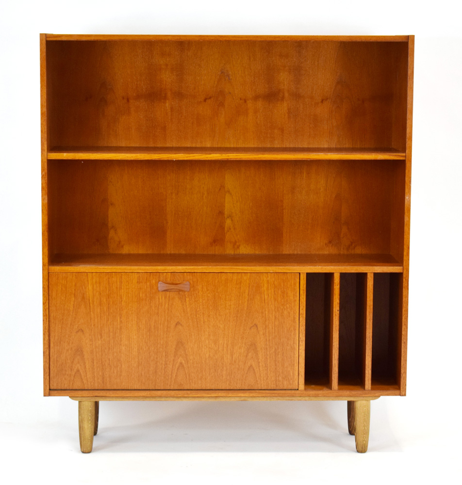 A 1960's Danish designed teak bookcase, the fixed shelf over a fall-front a LP storage,