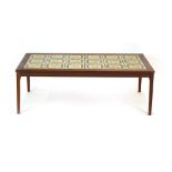 A 1970's teak coffee table, the surface inset with eighteen matching tiles,