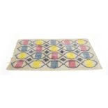 A 1970's multi-coloured rug with undulating motifs,