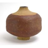 A studio pottery vase of baluster form with a rough two-tone brown ground, h.