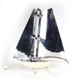 A 1930's chromed and cream enamel table lamp in the form of a yacht of Art Deco design,