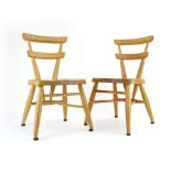 A pair of Ercol 'Red Dot' childrens stacking chairs in elm and beech,