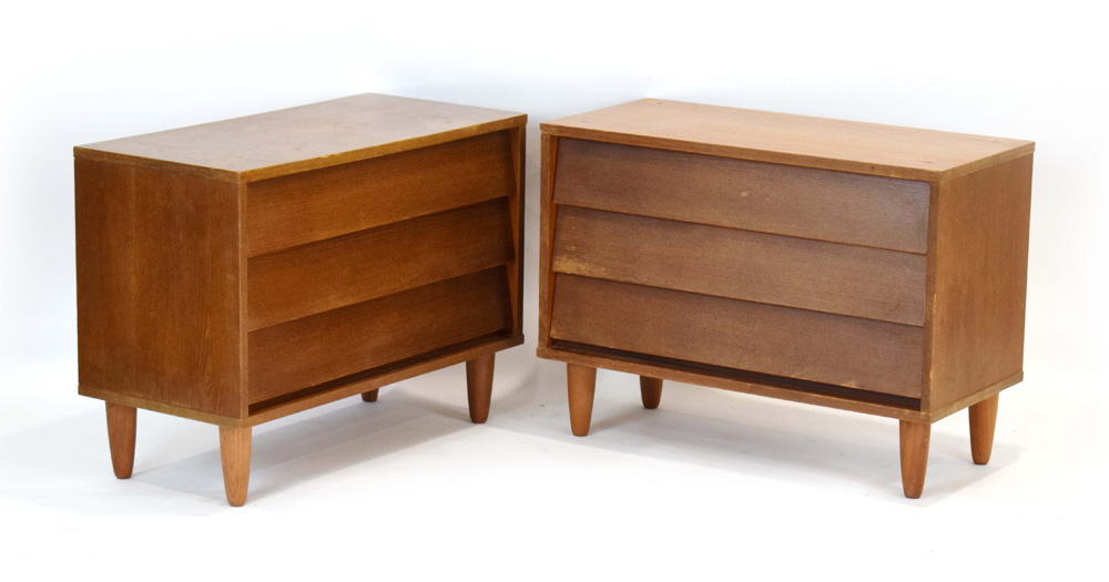 A pair of 1970's teak three-drawer chests, on later circular legs, w.