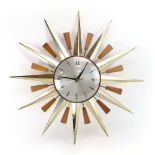A Metamex sunburst or starburst clock, with Arabic numerals and brass and beech rays, d.