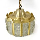 A 1970's brass coloured ceiling light with moulded glass panels around the sides