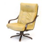 A 1970's cream button upholstered armchair on a bentwood frame with a five-star swivel base