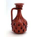 A 1950/60's Italian jug with a red glaze, numbered 2737, h.