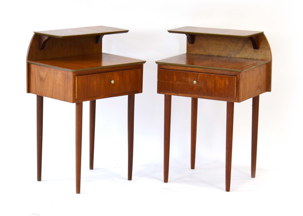 A pair of 1960's teak integral bedside cabinets with raised galleries and single drawers,