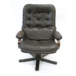 A 1970's brown button upholsted armchair on a bentwood frame and five-star swivel base