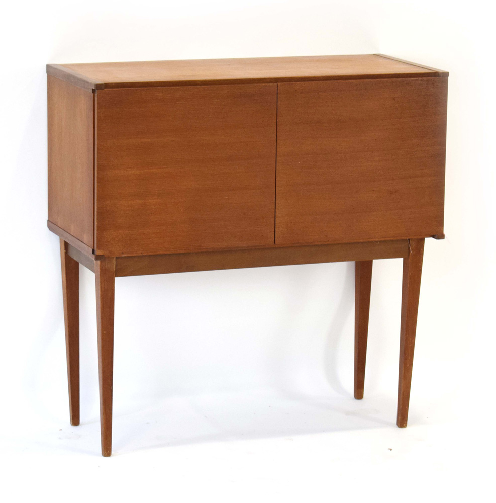 A 1970's teak twin-door cabinet on square tapering legs, w.