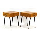 A pair of 1950/60's laminate bedside cabinets on ebonised tapering legs with brass caps, w.