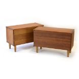 A pair of 1970's teak three-drawer chests, one with a fitted cutlery drawer, on later circular legs,