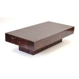 A 1970's Italian simulated burr walnut coffee table of rectangular form on a plinth,