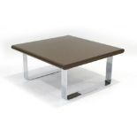 A 1970's occasional table, the square surface with scrolled ends on chromed sled-type supports,