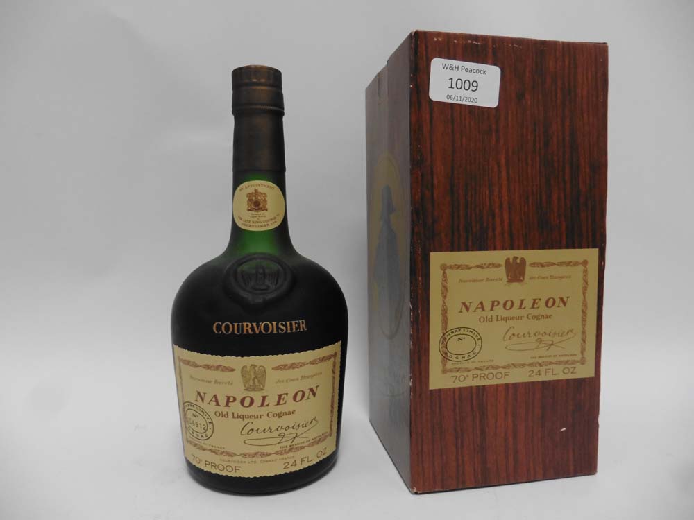 An old bottle of Courvoisier Napoloen Old Liqueur Cognac by Appointment to The Late King George VI