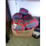 Box containing outdoor micro light sleeping bags in red and grey