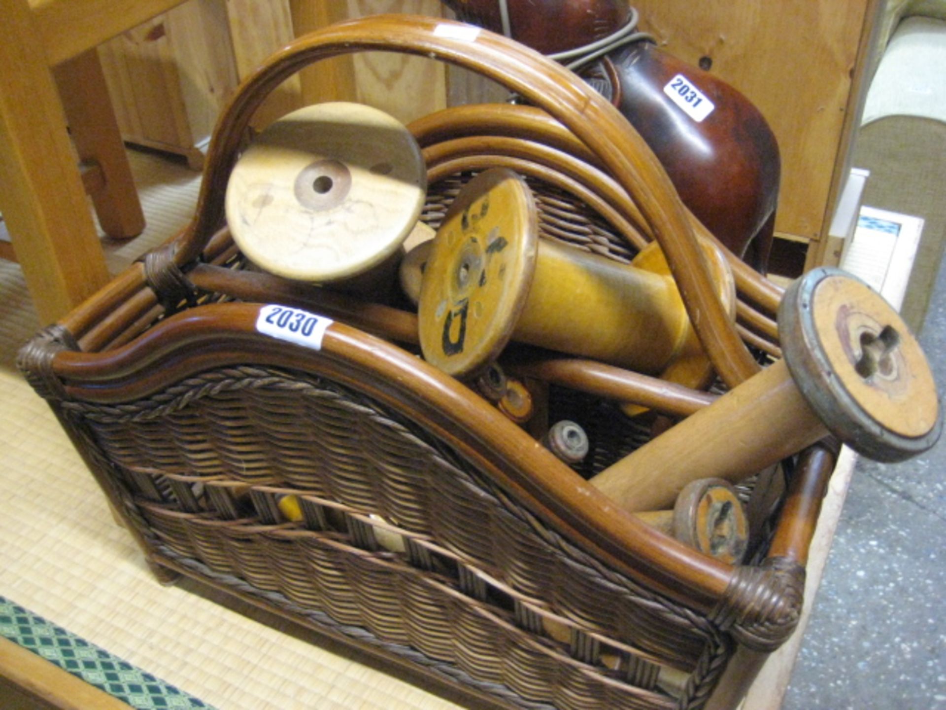 Wicker and bamboo basket containing wooden reels