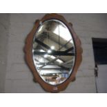 Oval framed and bevelled wall mirror