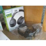 Boxed pair of Phillips wireless sports headphones and other pair of headphones