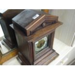 Wooden cased large mantle clock on tiered base