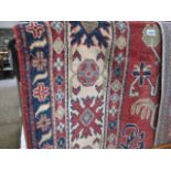 Cream red and blue figured and bordered rug