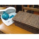 2 wicker baskets with 2 small blue glass vases