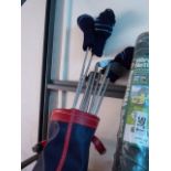 Blue and red leather golf bag with quantity of clubs