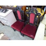 Pair of oak ornately carved high back chairs with red upholstered seats *Collector's Item: Sold in