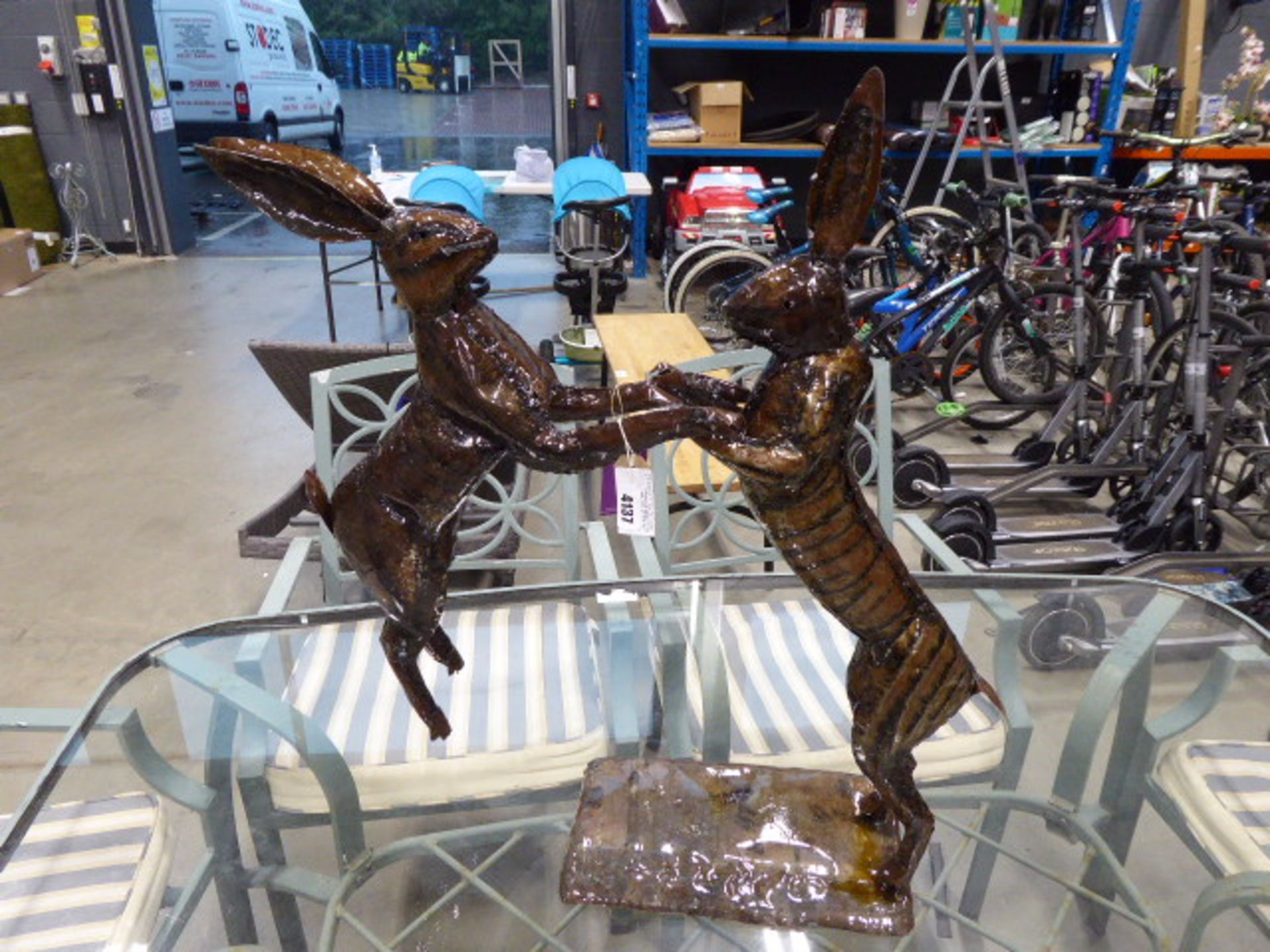 Metal statue of 2 fighting rabbits