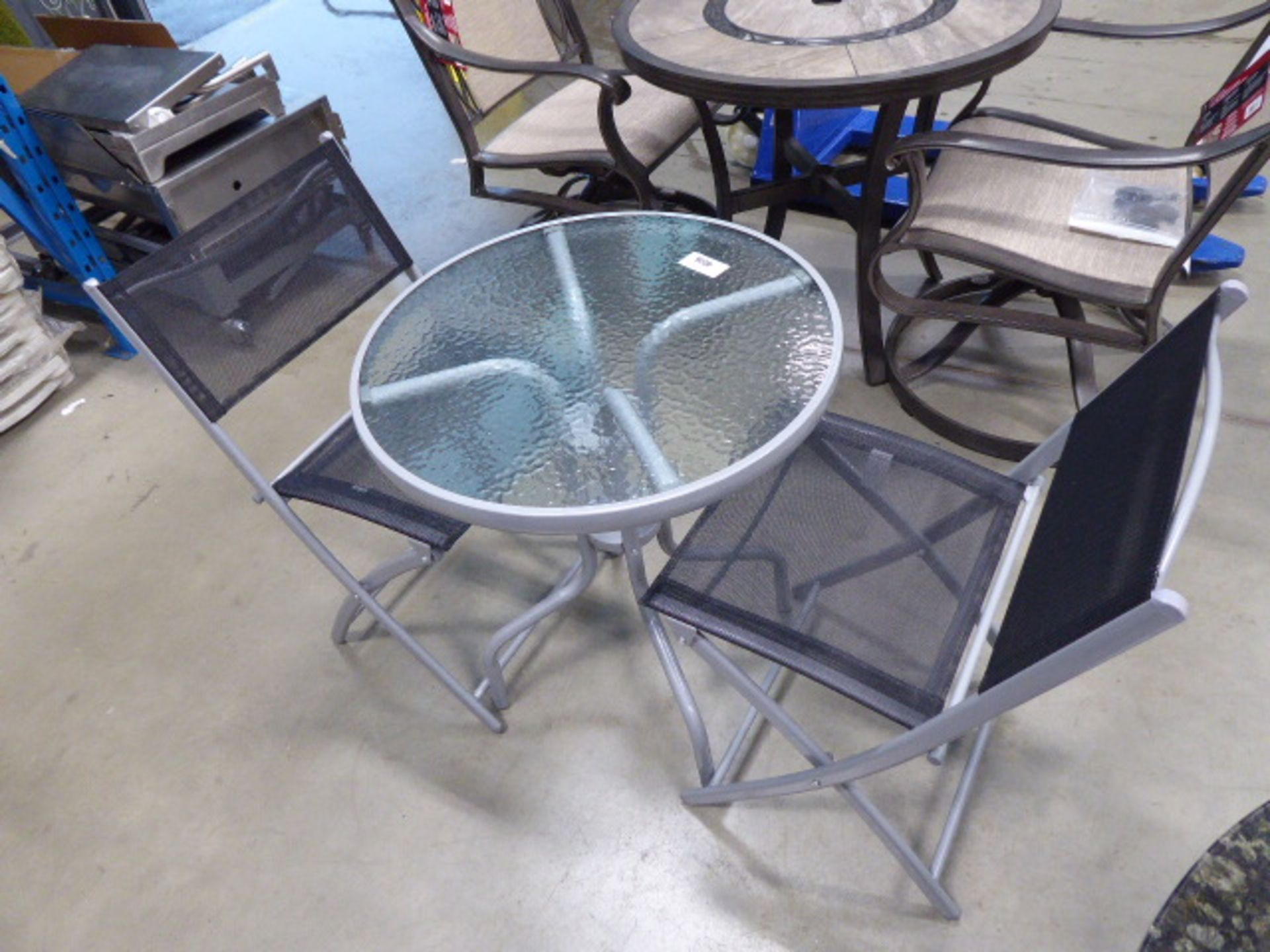 Small round glass topped garden table and 2 matching chairs