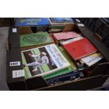 2 boxes containing reference books and travel guides
