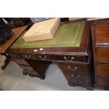 Reproduction mahogany twin pedestal desk having a gilt tooled green leather surface above an