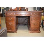 23 A Victorian mahogany and tooled leather twin-pedestal desk with an arrangement of nine drawers on